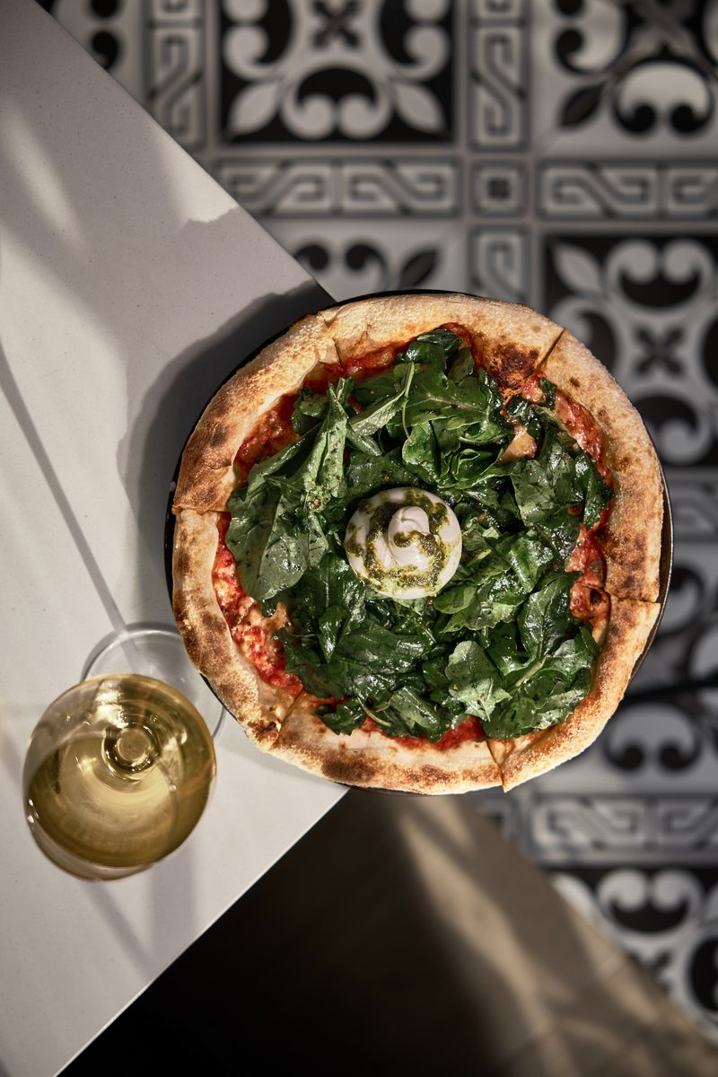 Valentino — Neapolitan pizza, overhead on patterned tile
