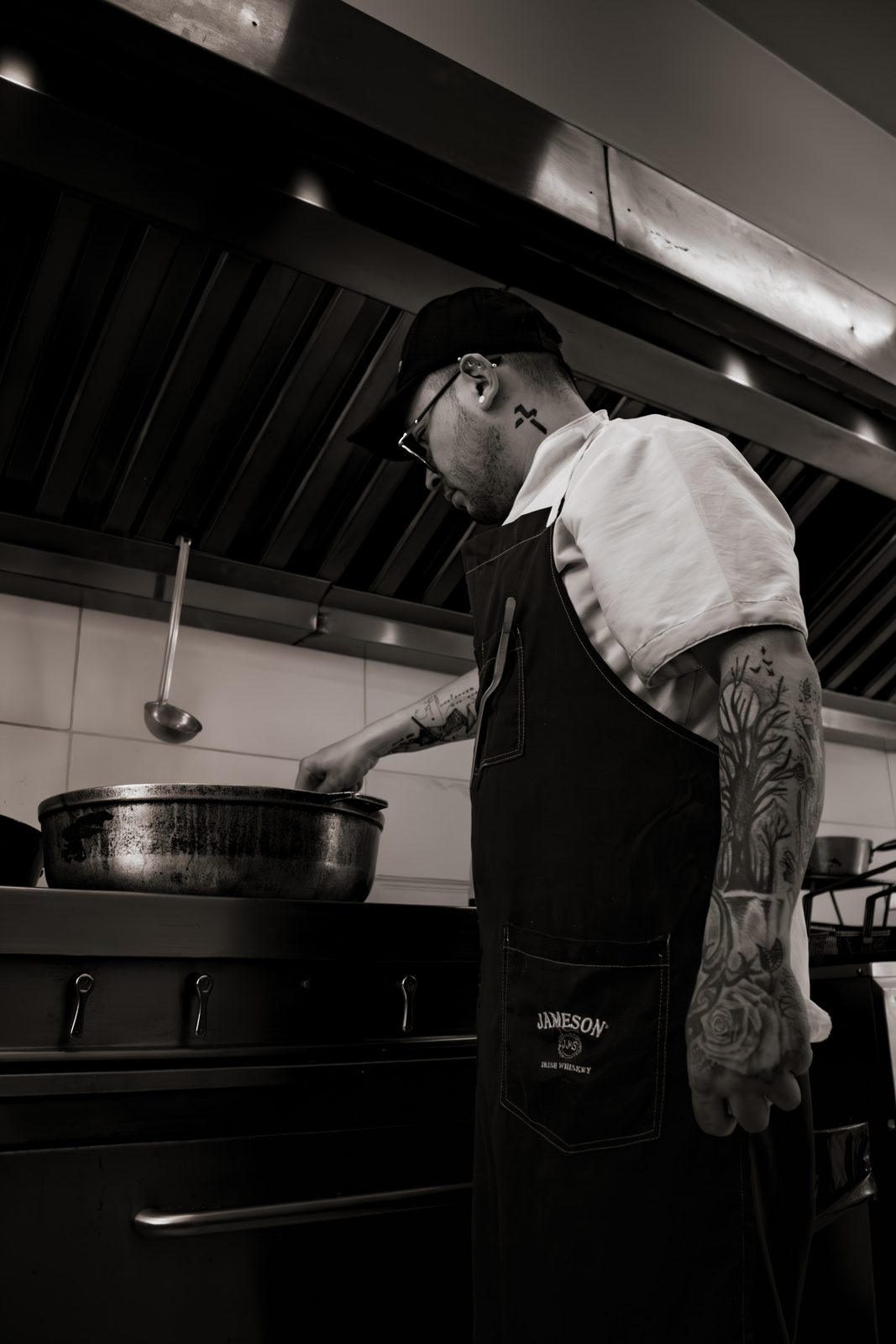 A chef at the pass, in black and white